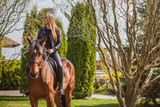 Woman on a horse at rancho. Horse riding, hobby time. Concept of animals and human