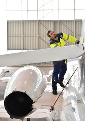 Airport workers check an aircraft for safety in a hangar