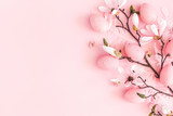 Easter composition. Easter eggs, pink flowers on pastel pink background. Flat lay, top view, copy space