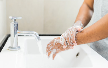 Man washing hands with soap.