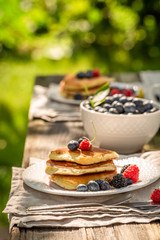 Homemade pancakes served with coffee in garden