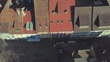 Drone flight with aerial view above church in old town of Winterthur in Switzerland. Tower and building roofs from above. Dynamic shots of European town.