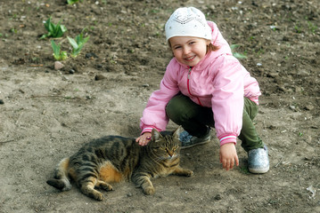 Little baby girl with street cat