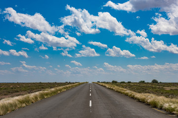 vibrant image of desert road and blue cloudy sky