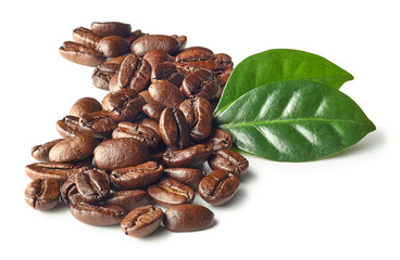 Heap of roasted coffee beans and leaves