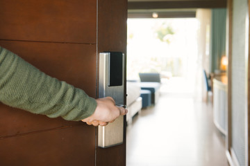 Picture showing hand of businessman opening hotel room