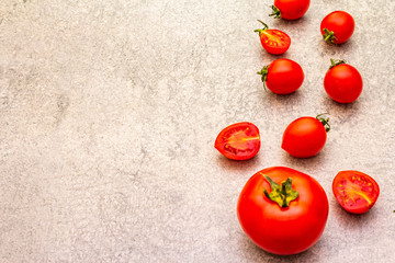 Fresh organic tomatoes. Food cooking stone background. Healthy vegetarian (vegan) eating concept, copy space, close up.