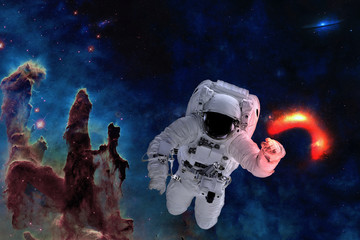Space astronaut near black hole glow near pillars of creation. Space adventure in outer space. Science fiction. Elements of this image were furnished by NASA
