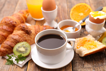 breakfast meal with coffee, egg and croissant