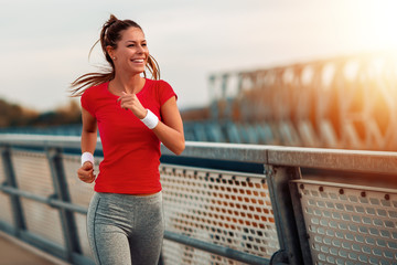 Young fitness woman running outdoors