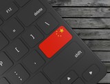 China flag enter key on white keyboard, on wood background. 3d render