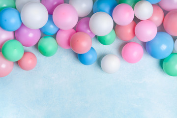 Party or birthday banner with colorful balloons on blue background top view. Flat lay style.