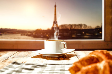 Fresh coffee with croisant and Paris landscape. 