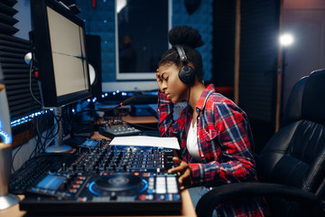 Female sound operator in audio recording studio