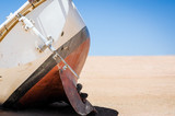 old broken yacht lay on the sand in the desert in Egypt