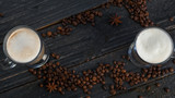 Top view coffee mug with coffee beans. Dark background with copyspace