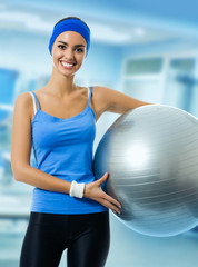 Woman with fitness ball, at gym