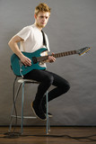 Young man playing electric guitar