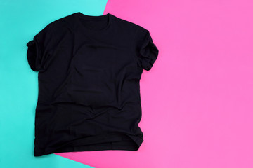 Wrinkled black mockup t-shirt on pink and blue pastel background