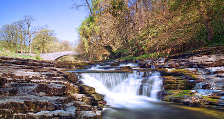 Bridge over the River Ribble and waterfalls at Stainforth Force