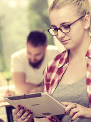 Student girl with tablet in front of her classmates