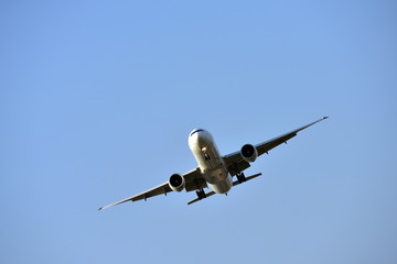 The plane is flying into the airport to land at Suvarnabhumi Airport. Thailand. The plane is tilting to turn into the airport.