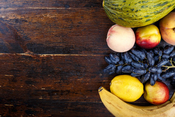 different fruits on wooden background