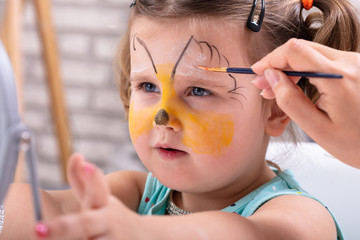 Painting Girl's Face With Color Brush