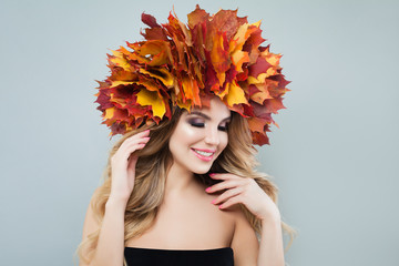 Beautiful model portrait. Autumn woman in colorful maple leaves crown