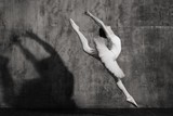 Ballerina in ballroom. Ballet dancer in studio. Black and white monochrome.