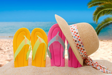 sandals and hat in the sand of the beach