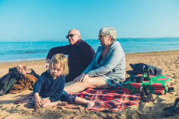 Toddler with grandparents on the beach