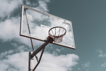 Basketball hoop against cloudy sky