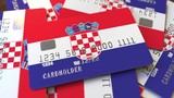 Pile of credit cards with flag of Croatia. Croatian banking system conceptual 3D animation