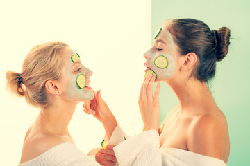 Girls friends sisters in bathrobes making clay facial mask. Anti age care. Stay beautiful. Skin care for all ages. Women having fun skin mask. Pure beauty. Beauty product. Spa and beauty care