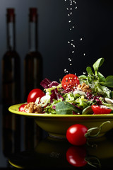 Green salad with cherry tomatoes,  sesame, walnuts and vegetable oil.
