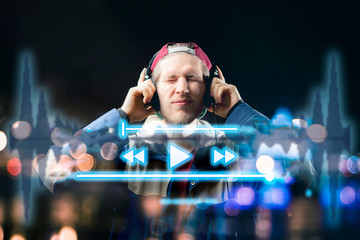 atrractive male use futuristic device to listen to music b