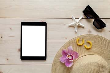 Travel background with accessories: woman hat, tablet, sunglasses, flower.. Vacation concept.