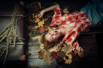 Girl wearing in autumn clothes on autumn sunny day. Beautiful sensual blonde. Happy young woman are preparing for autumn sunny day. Leaf fall. Fashion portrait of beautiful sensual woman.