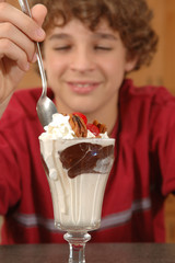 boy about to eat hot fudge sundae