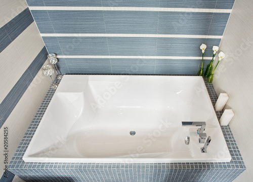  Modern bathroom in blue and gray tones with rectangular bath tub
