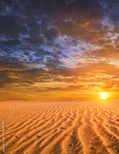Fototapeta dramatic sunset in a desert