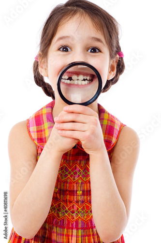 Fototapeta Girl showing teeth through a magnifier