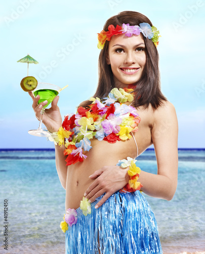  Woman in hawaii costume drink juice.