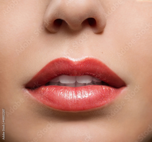 Fototapeta Close up of red glossy female lips