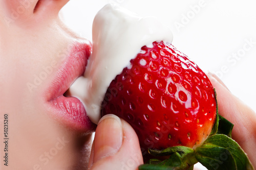 Fototapeta licking sour cream with sweet strawberry