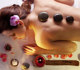 Woman getting stones spa procedures.