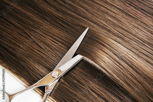 Fototapeta hairdresser scissors on the hair