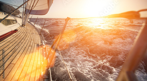  Yacht sailing during sunset.