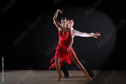 Lacobel dancers in ballroom against black background